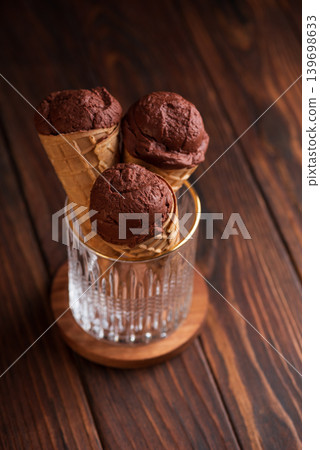 Chocolate Ice Cream Cones on Dark Wooden Background Chocolate Ice Cream Cones on Dark Wooden Background 139698633