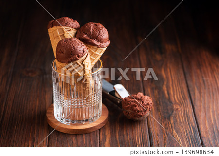Chocolate Ice Cream Cones on Dark Wooden Background Chocolate Ice Cream Cones on Dark Wooden Background 139698634