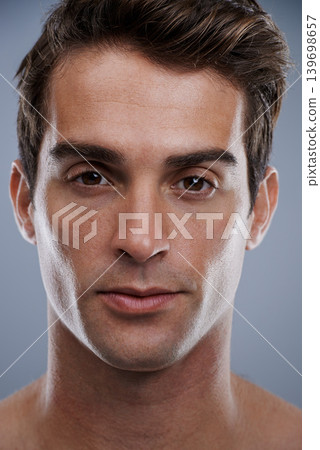 Portrait, skincare and man with cosmetics, dermatology and confident guy on grey studio background. Face, person or model with beauty or grooming with routine or aesthetic with healthy skin or glow Portrait, skincare and man with cosmetics, dermatology and confident guy on grey studio background. Face, person or model with beauty or grooming with routine or aesthetic with healthy skin or glow 139698657