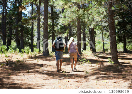 Couple of friends walking, hiking in nature and travel fitness, adventure or cardio in forest with wellness. Back of people trekking with backpack on path, eco friendly and carbon footprint journey Couple of friends walking, hiking in nature and travel fitness, adventure or cardio in forest with wellness. Back of people trekking with backpack on path, eco friendly and carbon footprint journey 139698659
