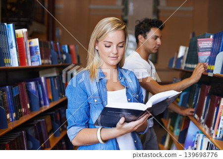 Reading, book or woman in a library to search at university, college or school campus for education. Bookshelf, learning or smart student with scholarship studying knowledge, research or information 139698776