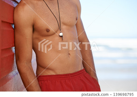 Muscular man, lifeguard and whistle at beach for security, emergency or help in surveillance, alert or safety at bay. Person, athlete or professional swimmer ready to assist on mockup space at ocean Muscular man, lifeguard and whistle at beach for security, emergency or help in surveillance, alert or safety at bay. Person, athlete or professional swimmer ready to assist on mockup space at ocean 139698795