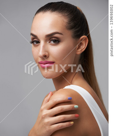 Cosmetics portrait, nail polish color and woman with studio makeup, beauty care or creativity in rainbow hand paint design. Manicure art, fresh treatment and salon girl isolated on grey background Cosmetics portrait, nail polish color and woman with studio makeup, beauty care or creativity in rainbow hand paint design. Manicure art, fresh treatment and salon girl isolated on grey background 139698802