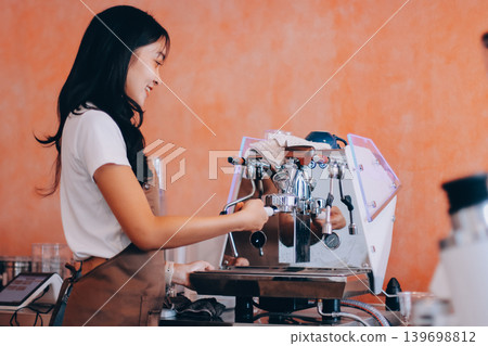 Young woman at barista school learning how to make espresso coffee. Young woman at barista school learning how to make espresso coffee. 139698812