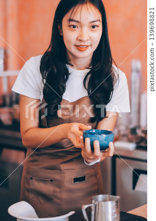 Young woman at barista school learning how to make espresso coffee. Young woman at barista school learning how to make espresso coffee. 139698821