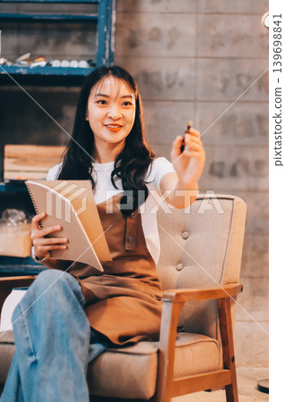 Female artist wears black hat posing near picture indoor the studio 139698841