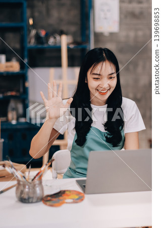 Female artist wears black hat posing near picture indoor the studio Female artist wears black hat posing near picture indoor the studio 139698853
