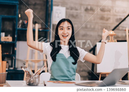 Female artist wears black hat posing near picture indoor the studio Female artist wears black hat posing near picture indoor the studio 139698860