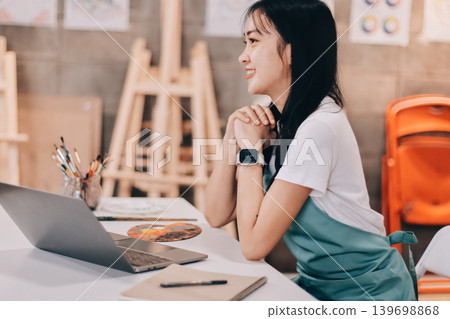 Female artist wears black hat posing near picture indoor the studio Female artist wears black hat posing near picture indoor the studio 139698868