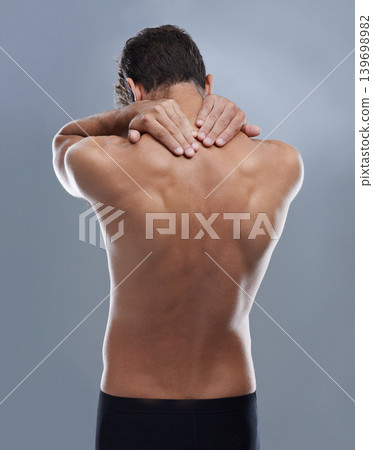Back pain, injury problem and studio person with medical emergency, sore backbone or osteoporosis. Backache, spine risk and model with body ache, fibromyalgia or hurt muscle strain on grey background Back pain, injury problem and studio person with medical emergency, sore backbone or osteoporosis. Backache, spine risk and model with body ache, fibromyalgia or hurt muscle strain on grey background 139698982