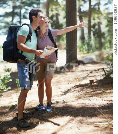 Couple, trekking in nature and map for direction, documents guide or location information of forest travel or journey. Man and woman hiking with infographics, search woods and pointing to destination Couple, trekking in nature and map for direction, documents guide or location information of forest travel or journey. Man and woman hiking with infographics, search woods and pointing to destination 139698987