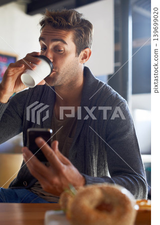 Phone, drinking and man with coffee at restaurant networking on social media, mobile app or internet. Research, technology and young male person reading on cellphone with cappuccino at cafe. Phone, drinking and man with coffee at restaurant networking on social media, mobile app or internet. Research, technology and young male person reading on cellphone with cappuccino at cafe. 139699020