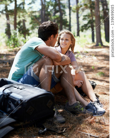 Couple, hiking break and travel in forest for outdoor fitness, adventure and wellness journey or health in nature. Happy man and woman relax on ground or talking of trekking destination with backpack Couple, hiking break and travel in forest for outdoor fitness, adventure and wellness journey or health in nature. Happy man and woman relax on ground or talking of trekking destination with backpack 139699085