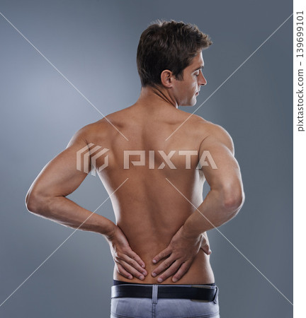 Back pain, injury crisis and studio man with medical emergency, sore spine or osteoporosis. Backache, anatomy and person massage joint ache, accident or hurt muscle strain on grey background Back pain, injury crisis and studio man with medical emergency, sore spine or osteoporosis. Backache, anatomy and person massage joint ache, accident or hurt muscle strain on grey background 139699101