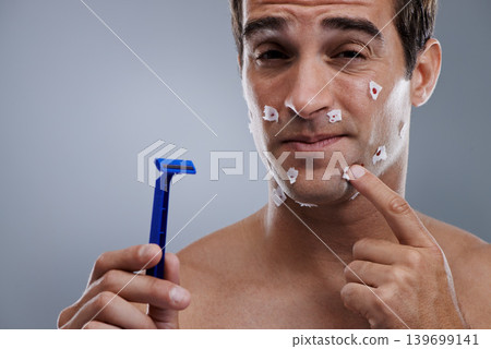 Man, face and shave cuts or pain for hair removal or hygiene injury with blood, tissue or maintenance. Male person, grey background and dermatology with beard or clean health, studio or mockup space Man, face and shave cuts or pain for hair removal or hygiene injury with blood, tissue or maintenance. Male person, grey background and dermatology with beard or clean health, studio or mockup space 139699141