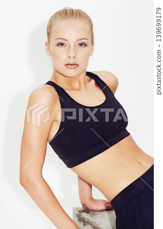 Portrait, fitness and young woman in studio isolated on a white background. Face, healthy body or serious person exercise, model training or sportswear for physical activity in workout in Switzerland Portrait, fitness and young woman in studio isolated on a white background. Face, healthy body or serious person exercise, model training or sportswear for physical activity in workout in Switzerland 139699179