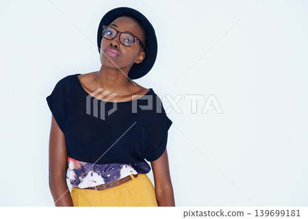 Fashion, space and portrait of black woman with attitude in studio on white background for hipster style. Model, glasses and hat with confident young african person in trendy clothing outfit Fashion, space and portrait of black woman with attitude in studio on white background for hipster style. Model, glasses and hat with confident young african person in trendy clothing outfit 139699181