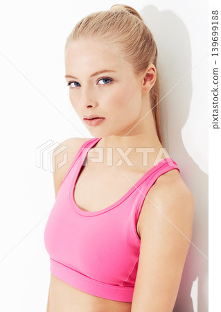 Portrait, fitness and serious young woman in studio isolated on a white background. Face, healthy body and person exercise, blonde model training or sportswear for physical workout in Switzerland Portrait, fitness and serious young woman in studio isolated on a white background. Face, healthy body and person exercise, blonde model training or sportswear for physical workout in Switzerland 139699188