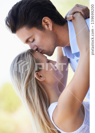Happy couple, kiss and hug in nature for romance, support or affection in outdoor bonding. Young man and woman forehead with smile for embrace, comfort or love in forest or woods together on date Happy couple, kiss and hug in nature for romance, support or affection in outdoor bonding. Young man and woman forehead with smile for embrace, comfort or love in forest or woods together on date 139699200