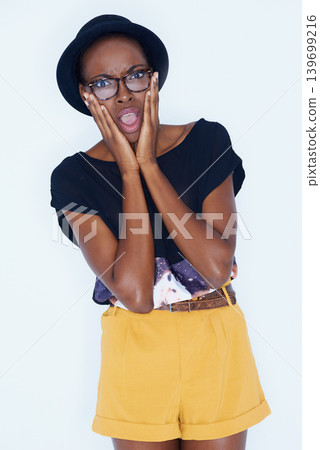Portrait, fashion and shock with hipster black woman in studio on white background for reaction or alert. Wow, surprise or omg and young person in glasses with wtf emoji or facial expression Portrait, fashion and shock with hipster black woman in studio on white background for reaction or alert. Wow, surprise or omg and young person in glasses with wtf emoji or facial expression 139699216