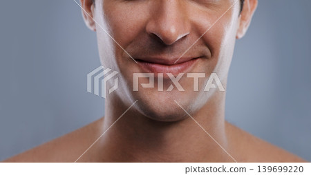Man, mouth and smile with skincare and lips with hygiene, jawline and satisfaction with treatment closeup. Grooming, confidence and face with male model in studio background for cosmetic shave Man, mouth and smile with skincare and lips with hygiene, jawline and satisfaction with treatment closeup. Grooming, confidence and face with male model in studio background for cosmetic shave 139699220