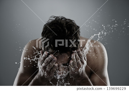 Water, splash and man cleaning face for bathroom routine, cleanse or fresh skincare in morning beauty treatment. Studio, skin hydration and model facial wash, hygiene and grooming on grey background Water, splash and man cleaning face for bathroom routine, cleanse or fresh skincare in morning beauty treatment. Studio, skin hydration and model facial wash, hygiene and grooming on grey background 139699229