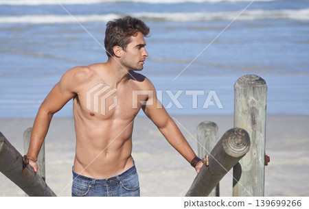 Walking, shirtless and young man at the beach on tropical vacation, adventure or holiday. Travel, stairs and confident male person on outdoor steps by the ocean or sea for summer weekend trip. Walking, shirtless and young man at the beach on tropical vacation, adventure or holiday. Travel, stairs and confident male person on outdoor steps by the ocean or sea for summer weekend trip. 139699266