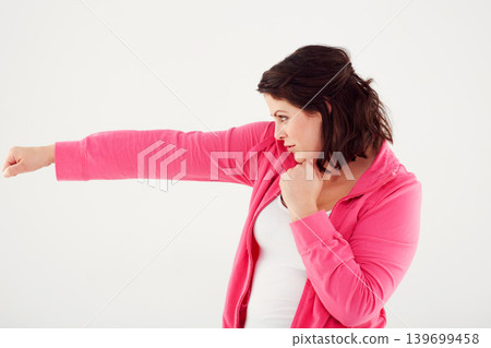 Woman, profile and boxing with fist in fitness, exercise or workout on a white studio background. Active female person, brunette or fighter in self defense practice, training or punches on mockup Woman, profile and boxing with fist in fitness, exercise or workout on a white studio background. Active female person, brunette or fighter in self defense practice, training or punches on mockup 139699458