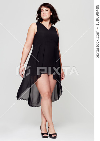 Fashion portrait, black dress and studio woman with glamour outfit, trendy style or elegant apparel. Classy, evening wear and female model confident in clothes isolated on white background Fashion portrait, black dress and studio woman with glamour outfit, trendy style or elegant apparel. Classy, evening wear and female model confident in clothes isolated on white background 139699489