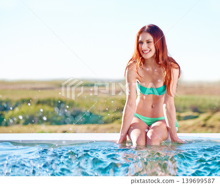 Swimming pool, bikini and redhead woman splash outdoor in nature for vacation, holiday or summer travel by mockup space. Ginger, happy girl and swimsuit for beauty, thinking and body relax by water Swimming pool, bikini and redhead woman splash outdoor in nature for vacation, holiday or summer travel by mockup space. Ginger, happy girl and swimsuit for beauty, thinking and body relax by water 139699587