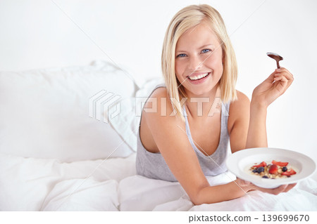 Woman, portrait and breakfast in bedroom, hotel and wake up for morning hospitality or accommodation. Relax, cereal or holiday with happy young person in bed of home, weekend or comfortable with food Woman, portrait and breakfast in bedroom, hotel and wake up for morning hospitality or accommodation. Relax, cereal or holiday with happy young person in bed of home, weekend or comfortable with food 139699670