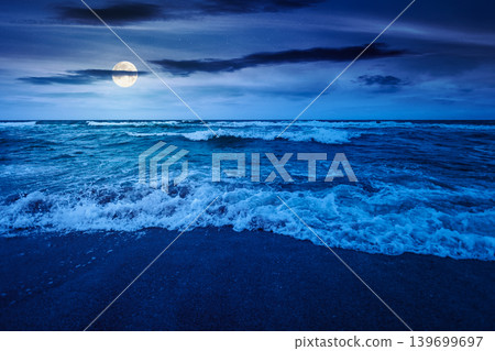 storm on the sandy beach at night. wonderful sea view with cloudy sky. full moon over salt water and crashing waves. mysterious view of bulgaria beach in summer. wind weather background storm on the sandy beach at night. wonderful sea view with cloudy sky. full moon over salt water and crashing waves. mysterious view of bulgaria beach in summer. wind weather background 139699697