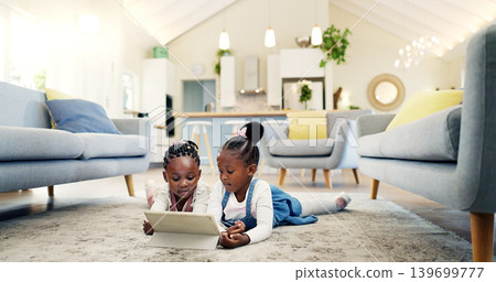 Black girl children on ground with tablet and relax, elearning or watch cartoon movie, sisters at home and screen time. Young female kids, streaming online and subscription to education app or film 139699777