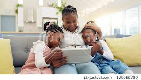 Happy, mother with her child and tablet on sofa in living room of their home together. Technology or connectivity, happiness or kissing and black family on couch streaming a movie in their house Happy, mother with her child and tablet on sofa in living room of their home together. Technology or connectivity, happiness or kissing and black family on couch streaming a movie in their house 139699780