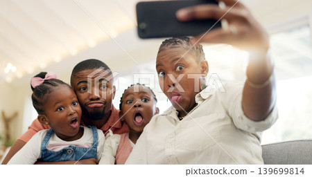 Black family, selfie and funny face, parents and kids at home, fun and bonding with memory for social media. Live streaming, playful and portrait, people with goofy expression in picture for post Black family, selfie and funny face, parents and kids at home, fun and bonding with memory for social media. Live streaming, playful and portrait, people with goofy expression in picture for post 139699814