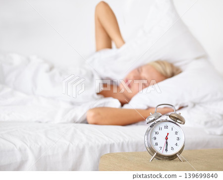 Alarm, clock and woman frustrated to wake up in morning on bed in home with fatigue from rest. Press, snooze and girl angry with time and tired start to day in bedroom and routine in apartment Alarm, clock and woman frustrated to wake up in morning on bed in home with fatigue from rest. Press, snooze and girl angry with time and tired start to day in bedroom and routine in apartment 139699840