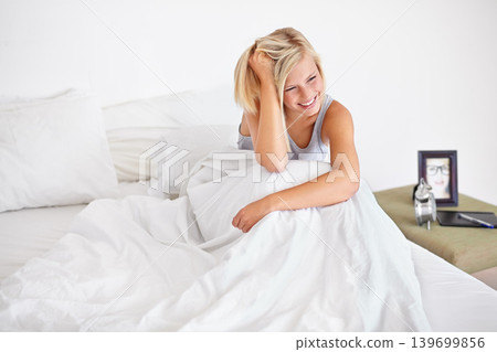 Happy, woman and wake up in bed to relax with comfort and wellness in home. Calm, girl and sitting in bedroom on holiday, vacation and rest for self care in apartment for healthy mindset or mood Happy, woman and wake up in bed to relax with comfort and wellness in home. Calm, girl and sitting in bedroom on holiday, vacation and rest for self care in apartment for healthy mindset or mood 139699856