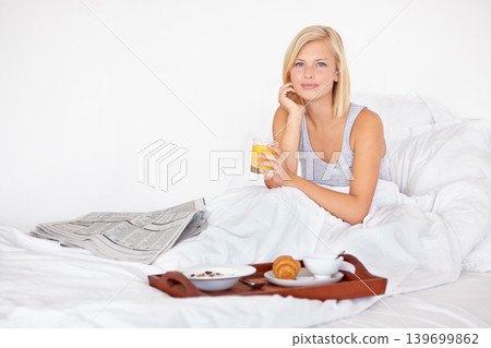 Healthy, breakfast and portrait of woman in bed with food, orange juice and relax with newspaper. Calm, girl and eating in bedroom on vacation with croissant, brunch and glass with drink in home 139699862