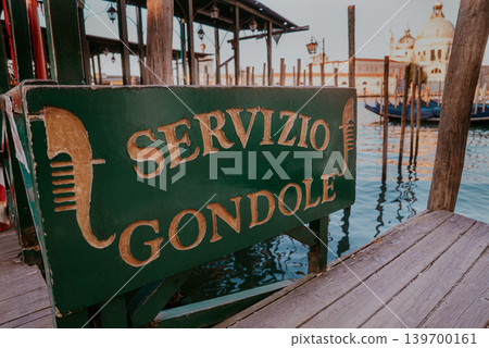 Gondola service pier and sign in Venice canal area. Venetian city life transport Gondola service pier and sign in Venice canal area. Venetian city life transport 139700161