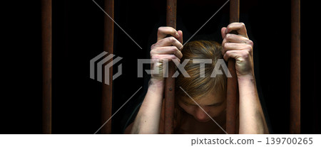Sad young girl in prison 139700265