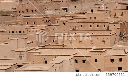 Traditional adobe village architecture with layered earthen homes in a desert landscape. 139700331