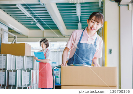 Female staff working in a warehouse: picking tasks Female staff working in a warehouse: picking tasks 139700396