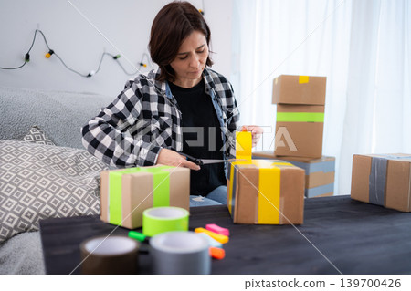 Girl At Home Packing A Cardboard Box, Packing The Cardboard Box Girl At Home Packing A Cardboard Box, Packing The Cardboard Box 139700426