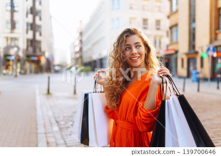 Young woman with shopping bags near mall. Summer Style. Shopping, lifestyle, sale concept. Young woman with shopping bags near mall. Summer Style. Shopping, lifestyle, sale concept. 139700646