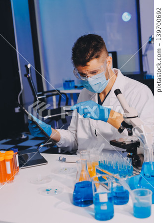 Lab technician experimenting in lab Lab technician experimenting in lab 139700692