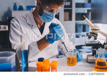 Lab technician experimenting in lab Lab technician experimenting in lab 139700694