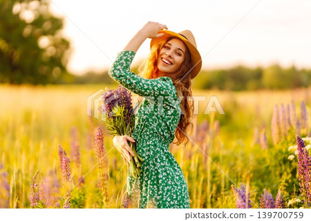 Young woman enjoying nature at sunset while walking. Nature concept. Young woman enjoying nature at sunset while walking. Nature concept. 139700759