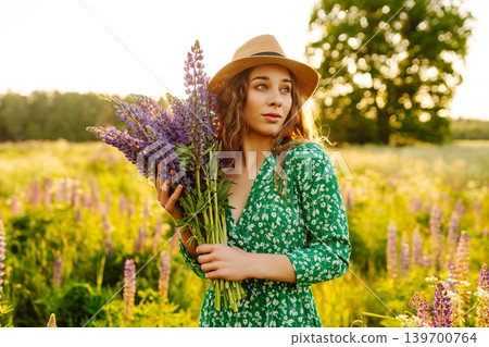 Young woman enjoying nature at sunset while walking. Nature concept. Young woman enjoying nature at sunset while walking. Nature concept. 139700764