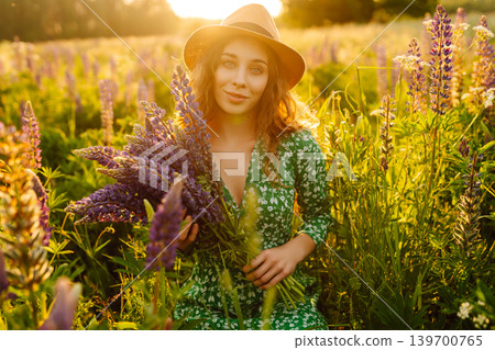 Young woman enjoying nature at sunset while walking. Nature concept. Young woman enjoying nature at sunset while walking. Nature concept. 139700765