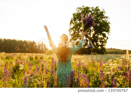 Young woman enjoying nature at sunset while walking. Nature concept. Young woman enjoying nature at sunset while walking. Nature concept. 139700767